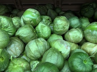 Wide shot of piles of tomatillos at a fresh produce section