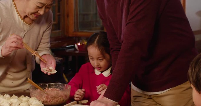 Happy family making dumplings at home,4K