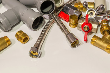 Spare parts and accessories for plumbing repair on a gray background