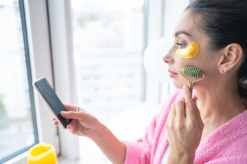 Convenient jade rolling massager for face stock photo