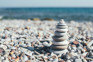 Stone pebble tower balancing on the beach.