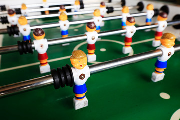dolls of a retro foosball table to play table football