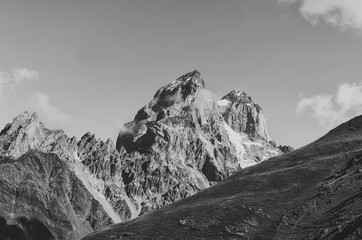 Fototapeta na wymiar Black and white shot of Mount Ushba, Main Caucasian ridge. Zemo Svaneti, Georgia. Autumn landscape.