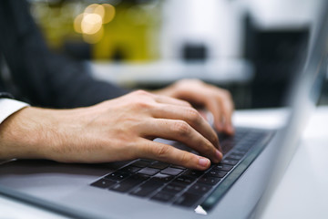 Male hands on the keyboard. Business man works on laptop computer and browsing internet, online working concept. Business man hand using laptop with social network working at home office.