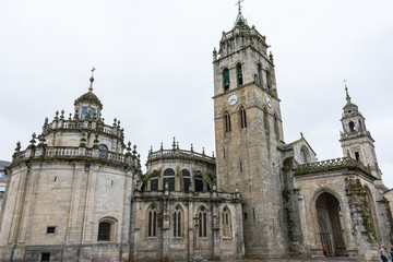 Fototapeta na wymiar Lugo cathedral church with tower on cloudy day
