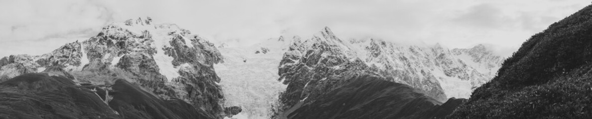 Black and white shot of Panoramic view of Mountain landscape. Mount Tetnuldi and glacier Lardaad. Ushguli, Svaneti, Georgia