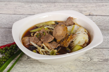 Thai style soup with meat and mushrooms
