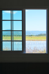 Obraz na płótnie Canvas View from the window to mountain and field.
