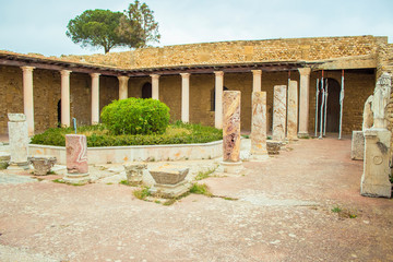 Fototapeta premium Ruins of ancient Carthage on Byrsa hill, near the capital of Tunisia, white buildings and green trees