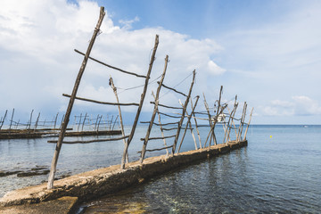 Fototapeta na wymiar The old docks with the typical wooden cranes of Savudrija, a small fishing village in Croatia