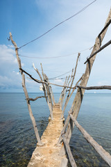 Fototapeta premium The small dock of Savudrija, a small fishing village on the Adriatic Sea in Croatia, with boat hanging from old wooden cranes