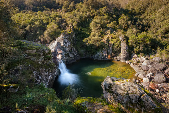 Mountain stream flowing into natural pool in Corsica