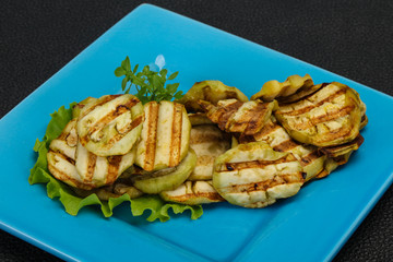 Grilled eggplant slices served basil