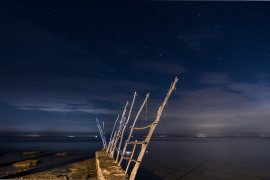 Long exposure night photo of wooden cranes of dock of Savudrija, Croatia