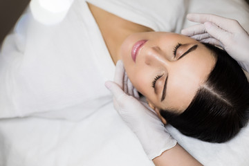Obraz na płótnie Canvas Closeup of young woman getting spa massage treatment. Woman enjoying massage in spa salon.