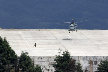 military helicopter lands in the landing zone