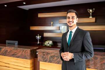 Smiling hotel worker welcoming guests