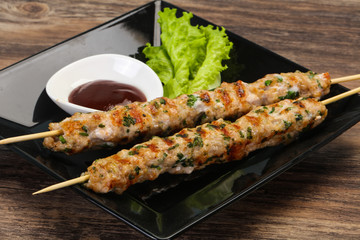 Minced pork skewer kebab with sauce