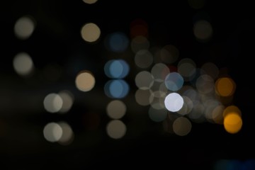 Blue white Bokeh or defocused circle light from city night. Abstract background
