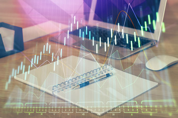 Double exposure of forex graph and work space with computer. Concept of international online trading.