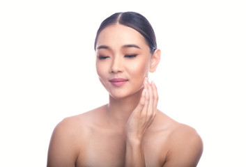 Beautiful Young Asian Woman with Clean Fresh Skin isolate on white background. Spa, Face care, Facial treatment, Beauty and Cosmetics concept. Right hand touch jaw. Eye close. Smile.