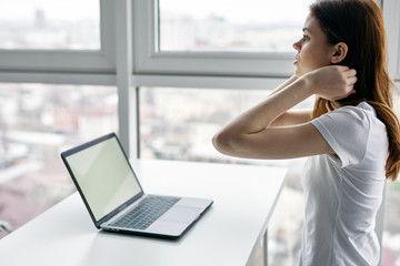 young woman working on laptop in cafe