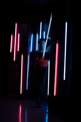 Slim woman with neon lamp
