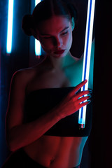 Slim woman with neon lamp