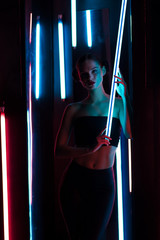Slim woman with neon lamp