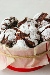 Cracked chocolate chip cookies in powdered sugar.