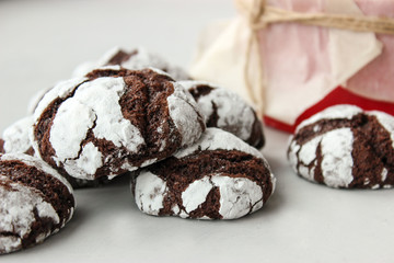 Cracked chocolate chip cookies in powdered sugar.