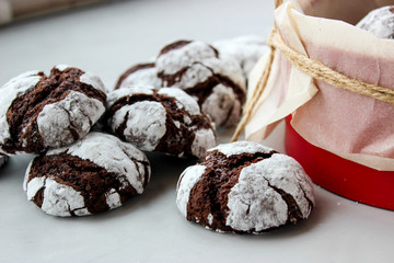 Cracked chocolate chip cookies in powdered sugar.