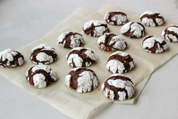 Cracked chocolate chip cookies in powdered sugar.