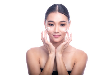 Beautiful Young Asian Woman with Clean Fresh Skin isolate on white background. Spa, Face care, Facial treatment, Beauty and Cosmetics concept. Cream on face, finger touch, smile.