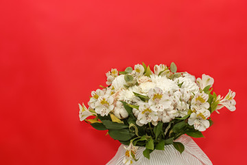 White bouquet of chrysanthemums on red background. Wedding bouquet. Valentine day. Cotton