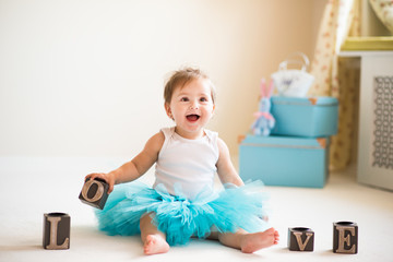 Amazing young smiling little girl with LOVE cubes