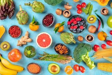 Vegan food. Healthy diet concept. Fruits, vegetables, pasta, nuts, legumes, mushrooms, shot from...