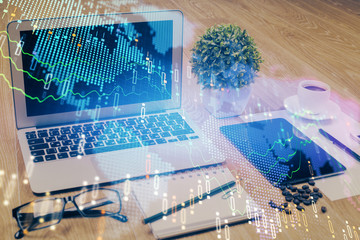 Financial graph colorful drawing and table with computer on background. Double exposure. Concept of international markets.