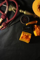 bowl with tobacco for hookah. fruits on a dark background. smoking hookah