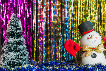 christmas tree and snowman at colorful holiday background
