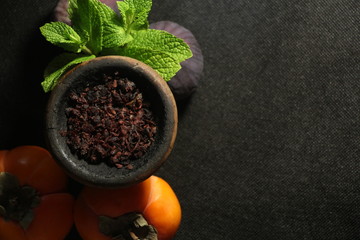 bowl with tobacco for hookah. fruits on a dark background. smoking nargile