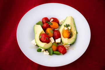 Fototapeta na wymiar Avocado and Tomato Salad with Feta Cheese