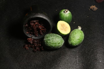 bowl with tobacco for hookah. fruits on a dark background. smoking nargile