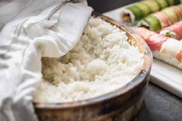 Cooked rice in a typical Japanese wooden vessel hangiri. Pile of rice before ready to prepare sushi