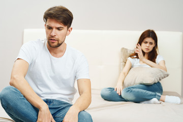 Fototapeta na wymiar young couple sitting on sofa and watching tv