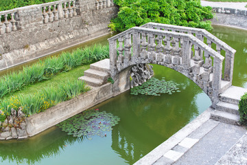 The Ferrari Garden (Ferrarijev Vrt) below the fortified settlement of Štanjel by architect Max Fabiani. The most important park complex in Slovenia. Venetian Bridge surrounded by plants