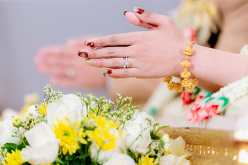 Hands pouring blessing water into bride's bands, Thai wedding.Wedding ceremony in Thailand.