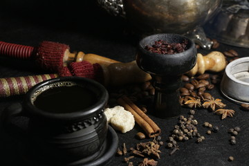 bowl with tobacco for hookah. fruits on a dark background. smoking hooka