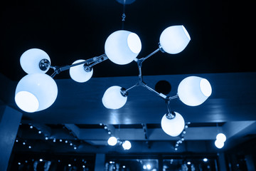 A modern chandelier hangs from the ceiling.