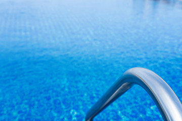 Fototapeta na wymiar Grab bars stainless in the blue swimming pool